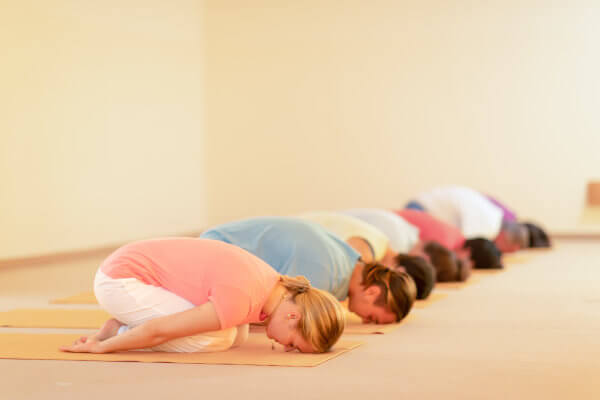 Gentle Yoga: A group of yoga students in the Child's Pose.